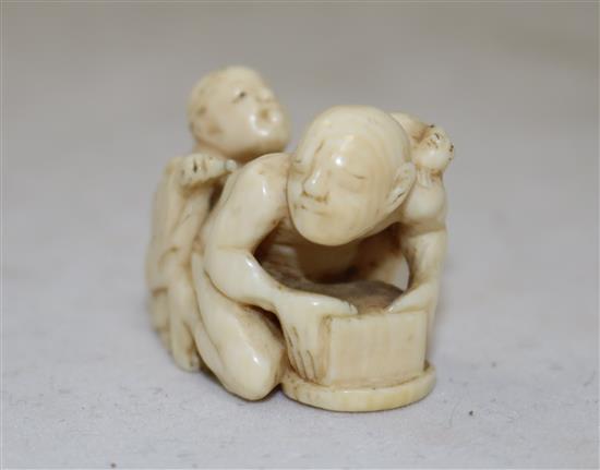 A Japanese ivory netsuke of a rat catcher and a boy, Meiji period, length 3.9cm